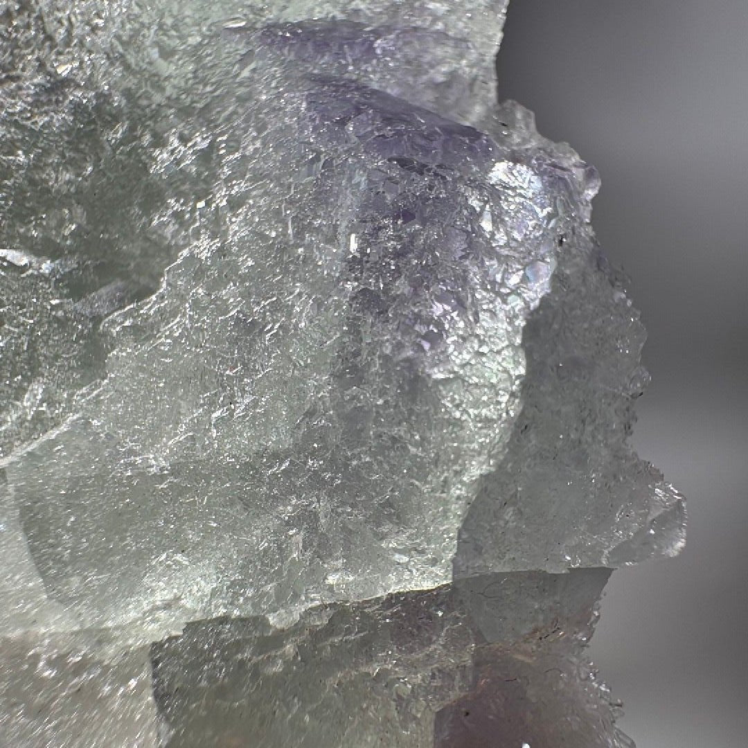 Detail of violet purple banding sitting inside the pale green fluorite mass