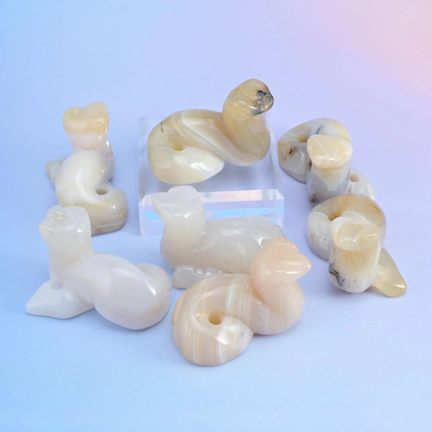 Milky opalite snake figurines with a soft translucent blue glow