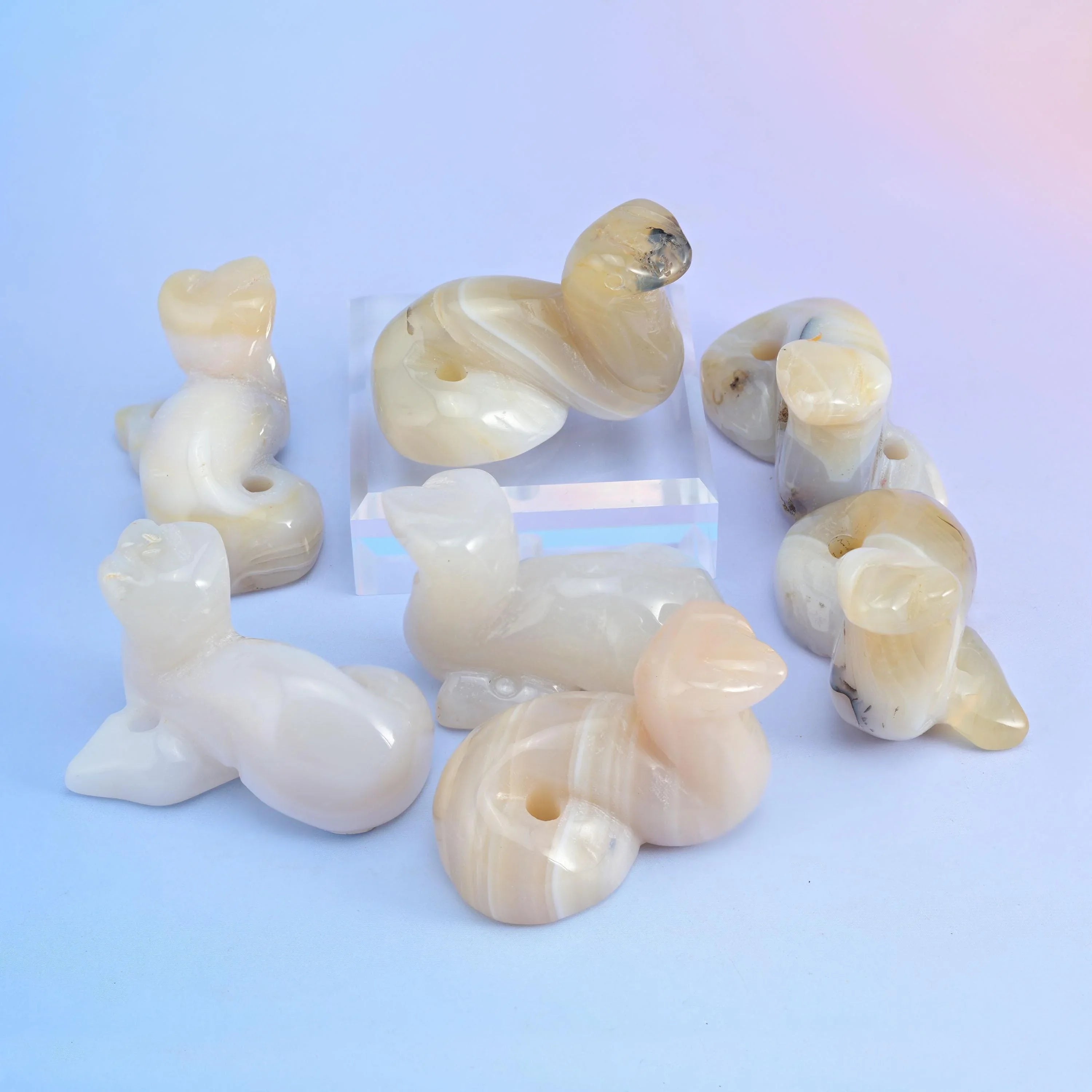 Milky opalite snake figurines with a soft translucent blue glow