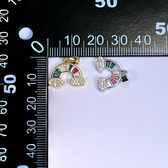 Gold and silver Rainbow Zirconia Charms on a black millimeter ruler, both finishes shown together against the mm markings.
