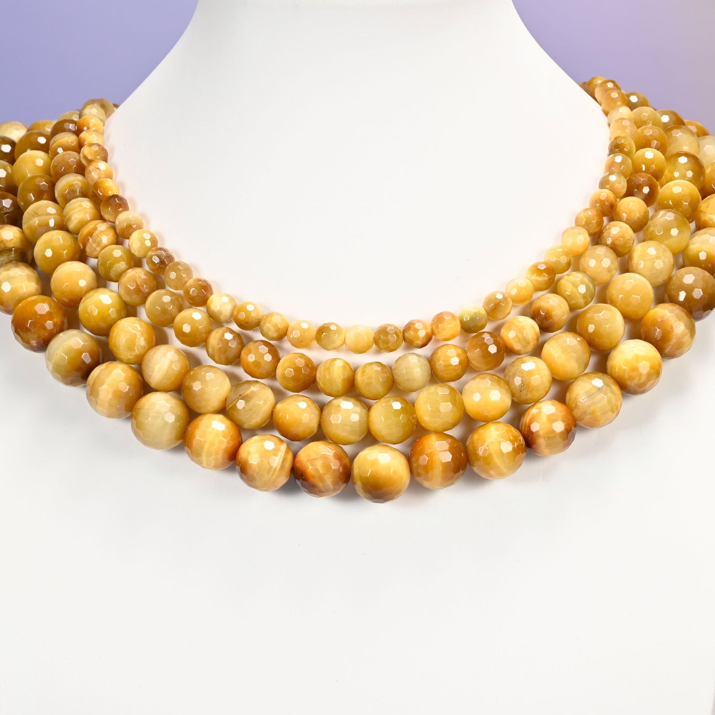 Close-up of golden brown gold tiger eye round beads, showing the faceted finish and natural brown tone.