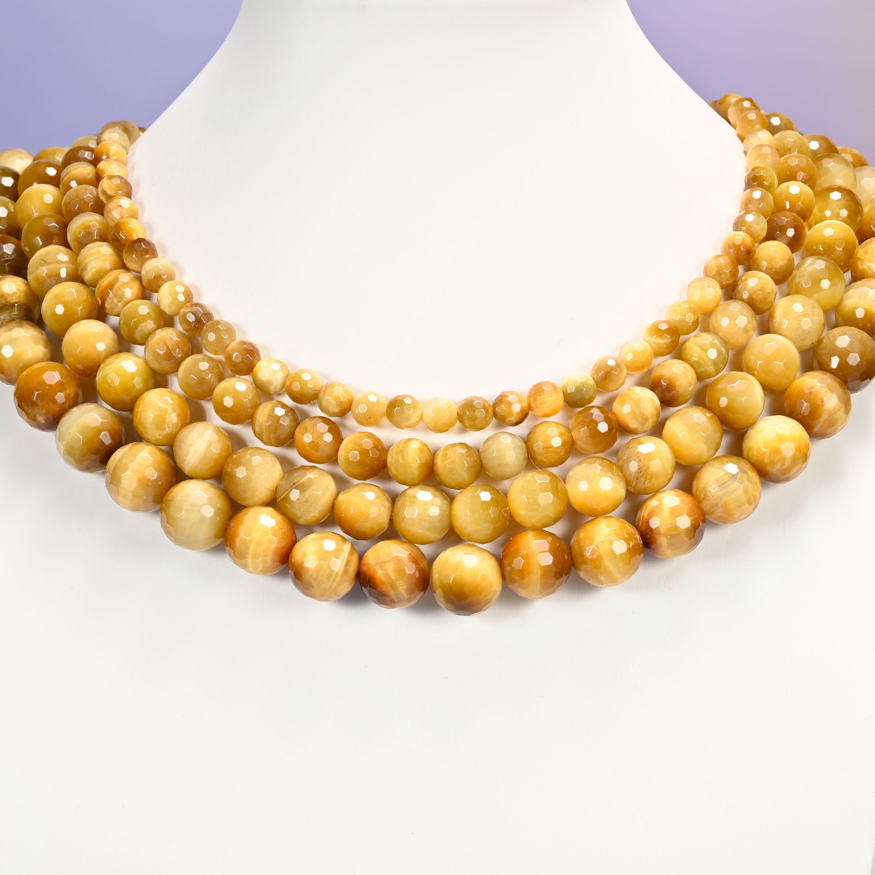 Close-up of golden brown gold tiger eye round beads, showing the faceted finish and natural brown tone.