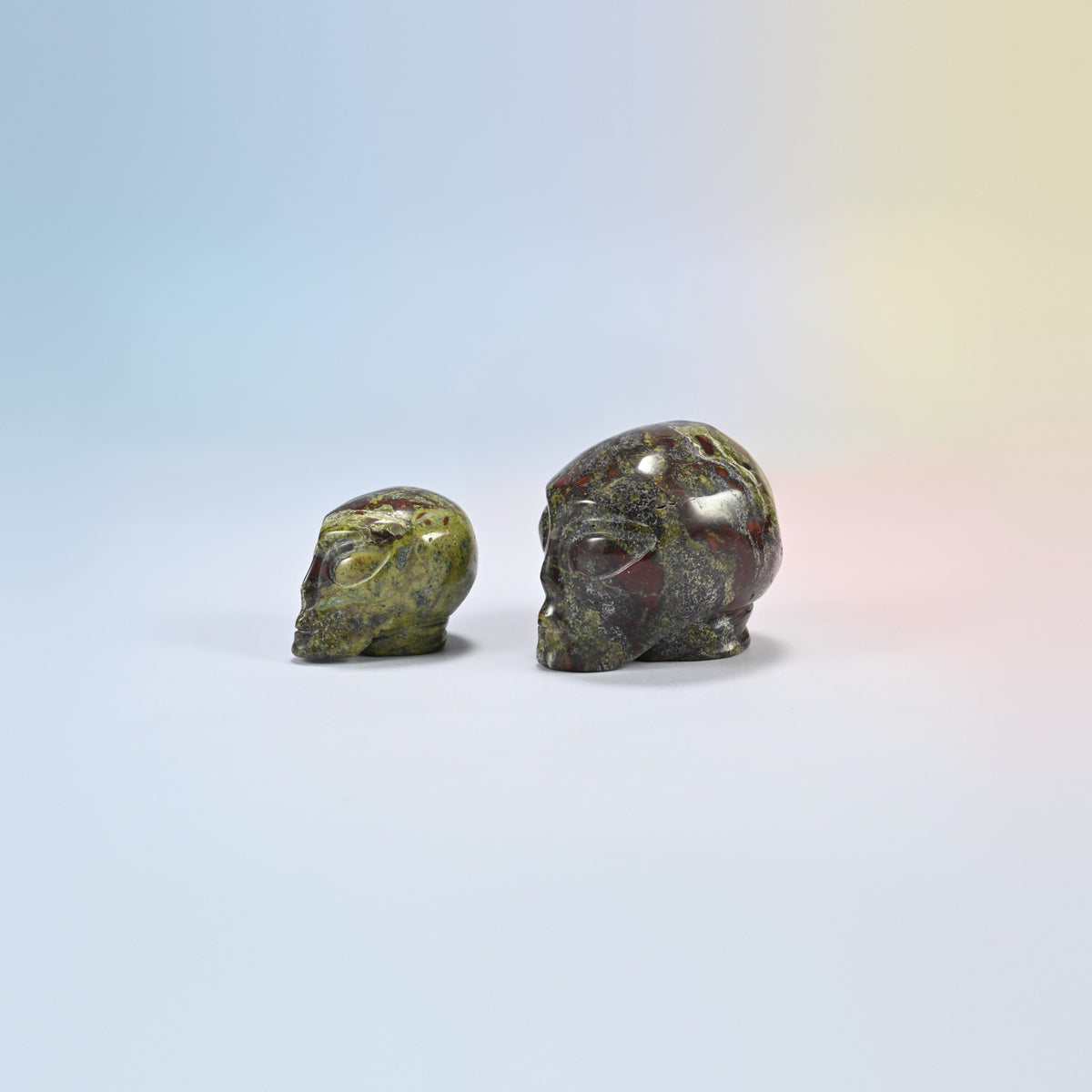 Two dragon bloodstone alien head crystal carvings, 1.5 inch and 2 inch, dark green natural stone with red patches