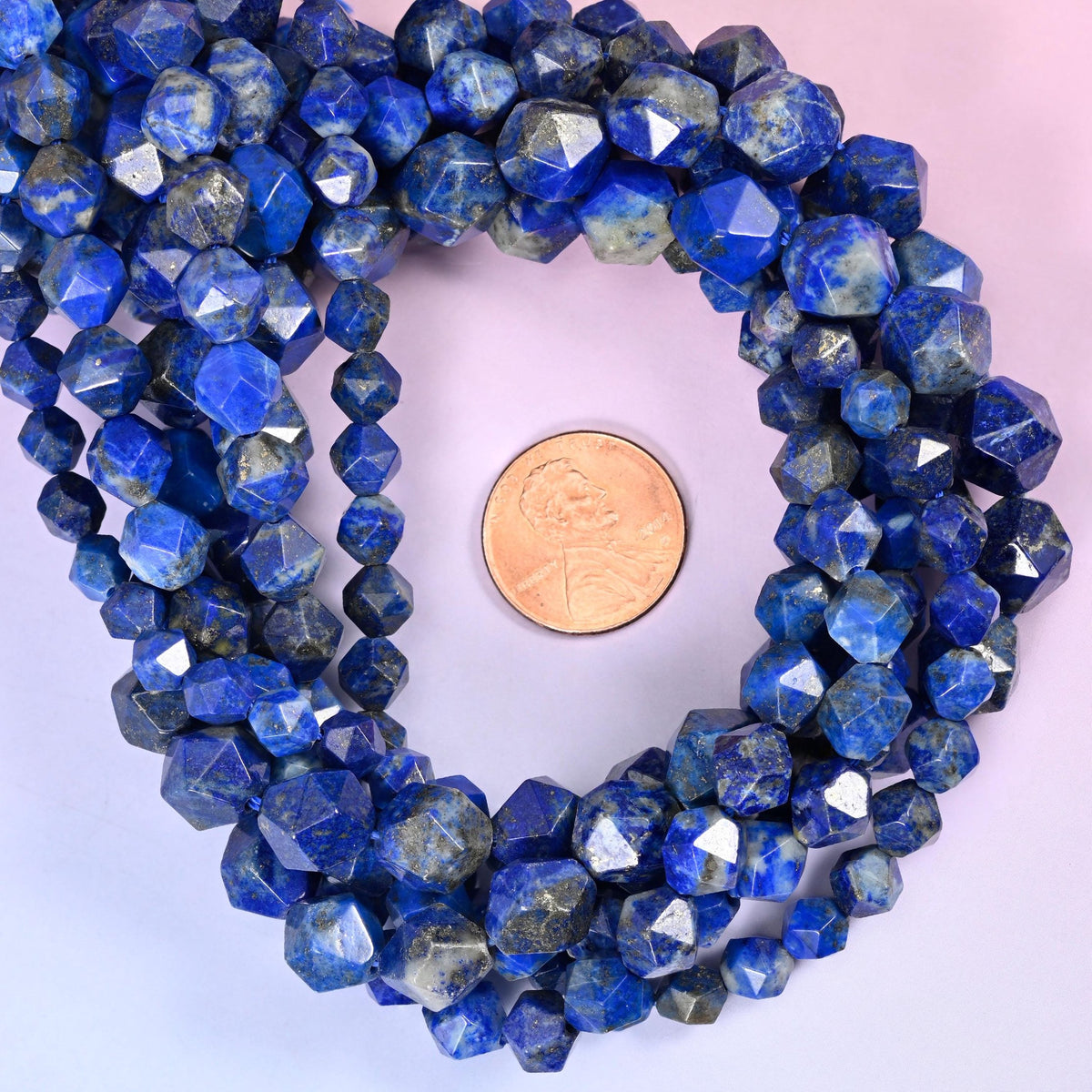 Blue Lapis Lazuli beads coiled around a US penny, drill hole approximately 1.0mm, natural stone in deep blue and white