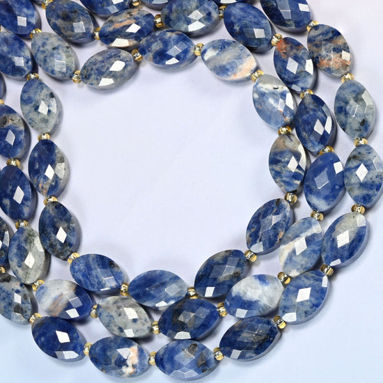 Orange sodalite faceted flat oval beads curved into an open loop, blue stone with orange patches