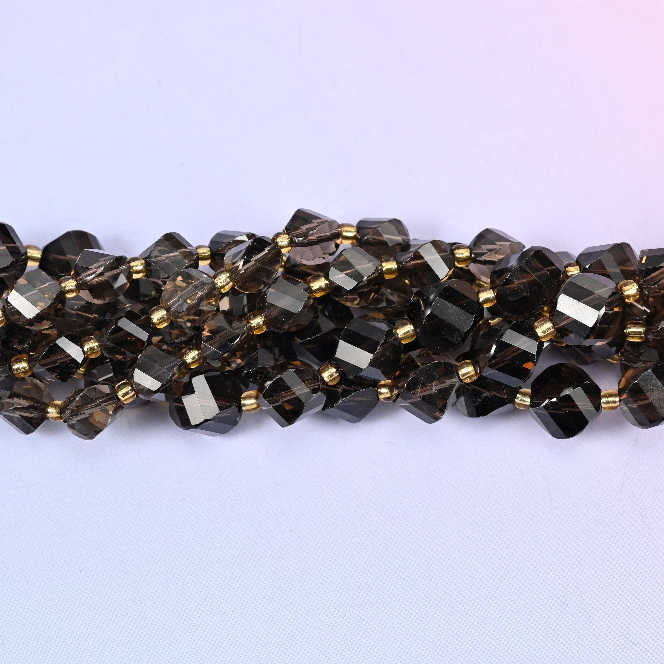 Smoky Quartz Faceted Spiral Twist Beads, translucent coffee brown deepening to near-black in the thicker beads