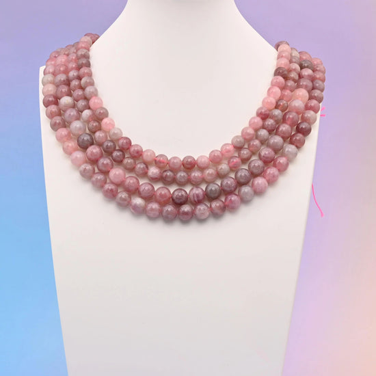 Madagascar Rose Quartz beads, smooth round shape.