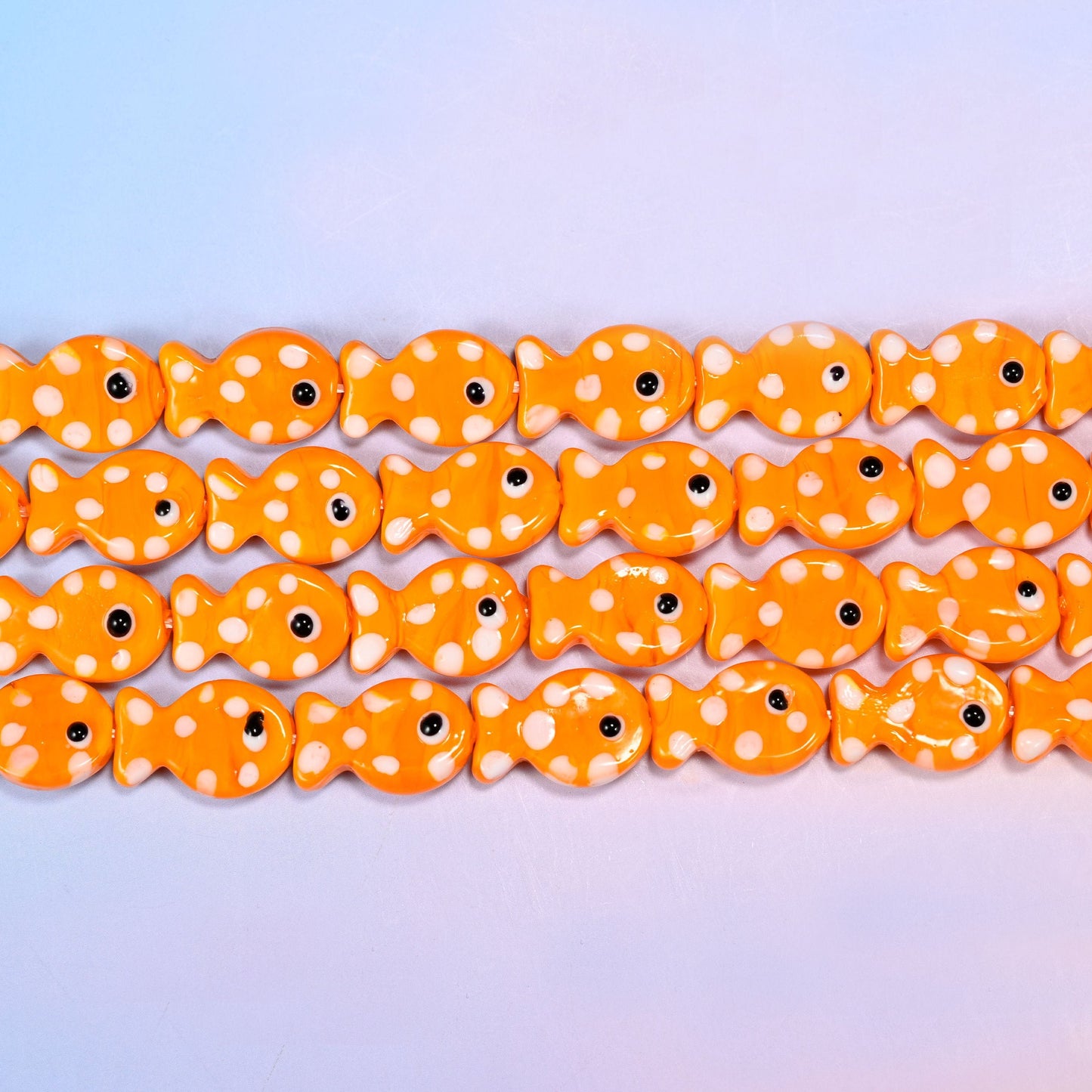 Fish glass beads in warm tangerine orange with white dots
