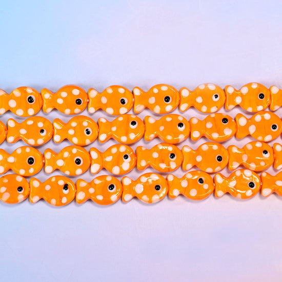 Fish glass beads in warm tangerine orange with white dots
