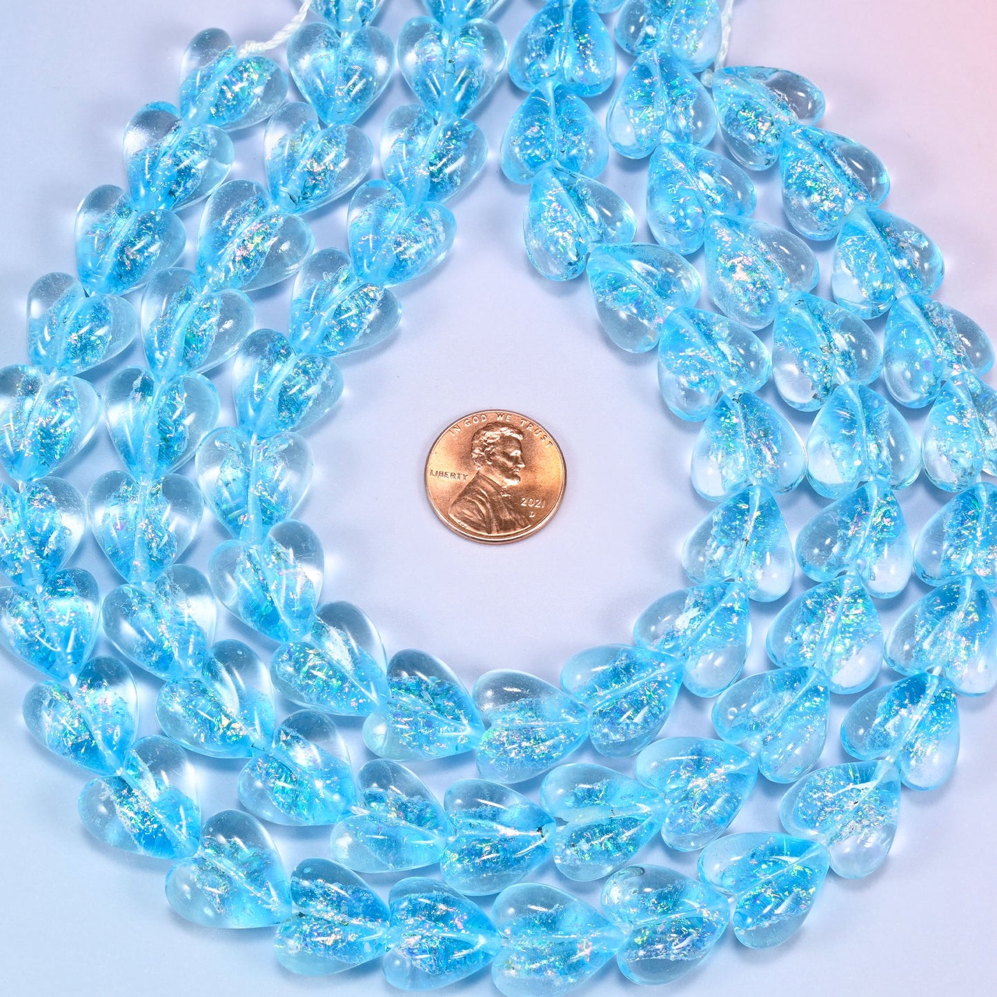Iridescent light blue heart glass beads at true 16x15mm scale, 24 beads per 11.5 inch strand