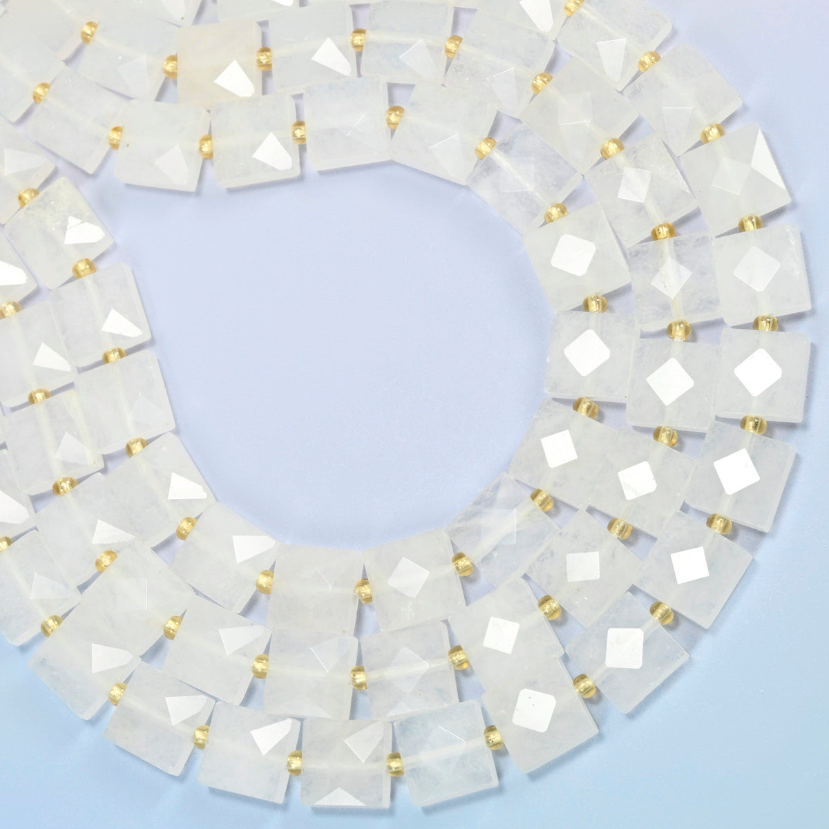 Clear quartz faceted flat square beads curved into an open loop, frosted white and clear beads