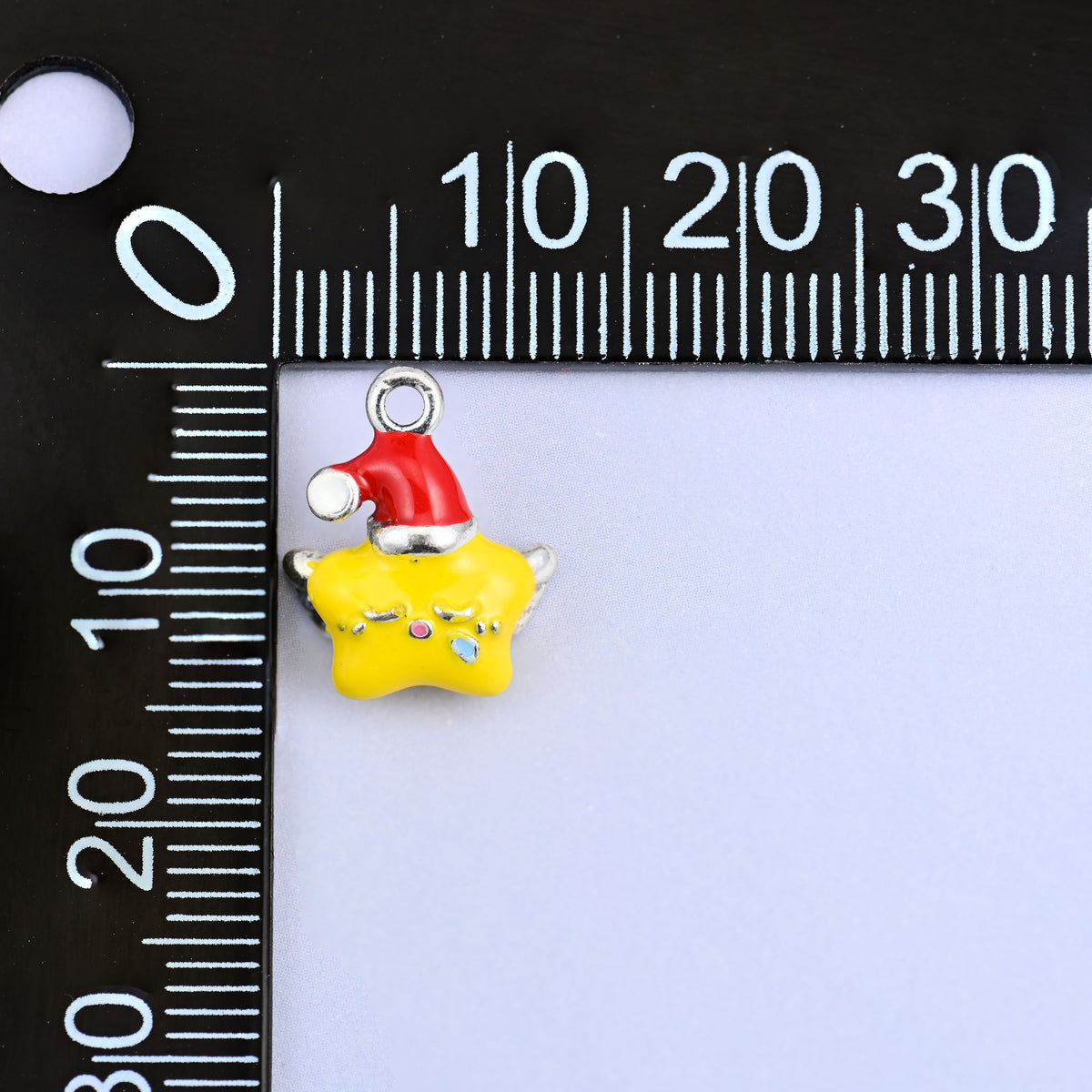 Star charm with wings measuring 14 x 11.35mm, small enough for a bracelet or an earring.