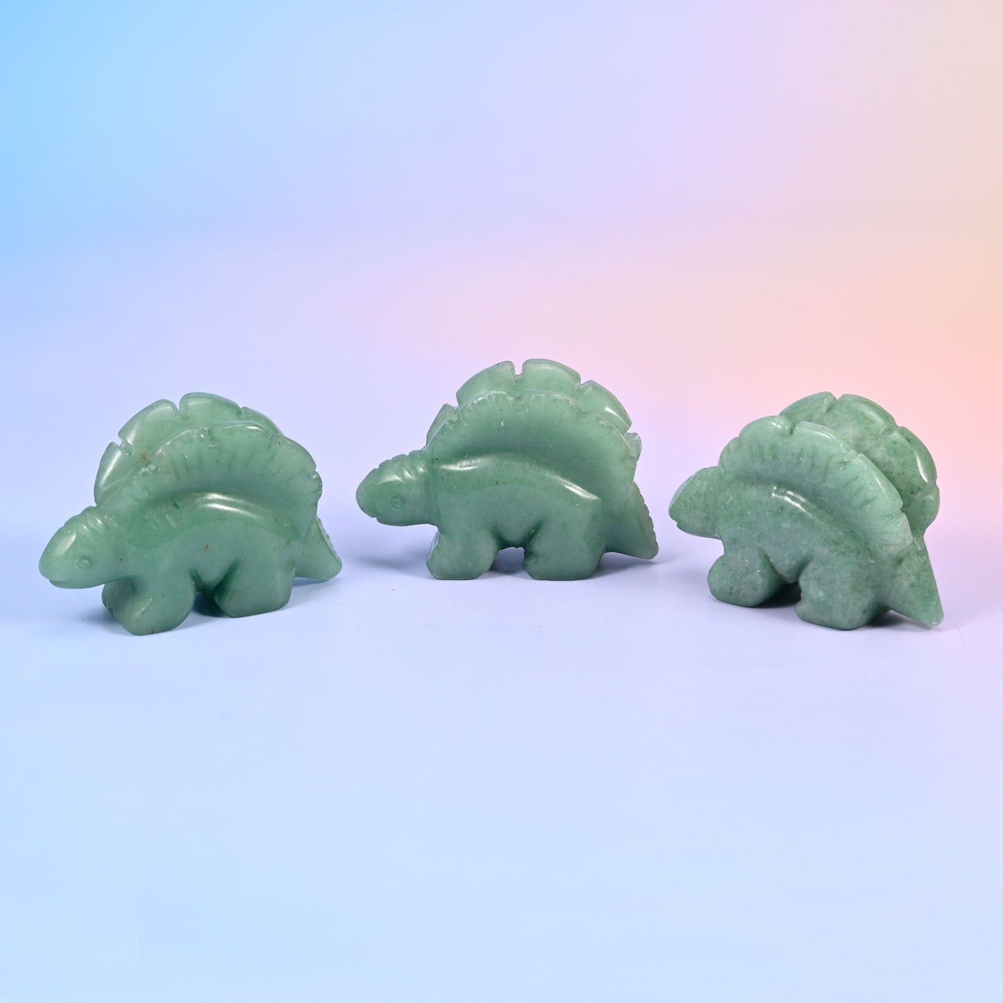 Stegosaurus carving offered in 12 natural stone options, from mint green and brick red to banded brown