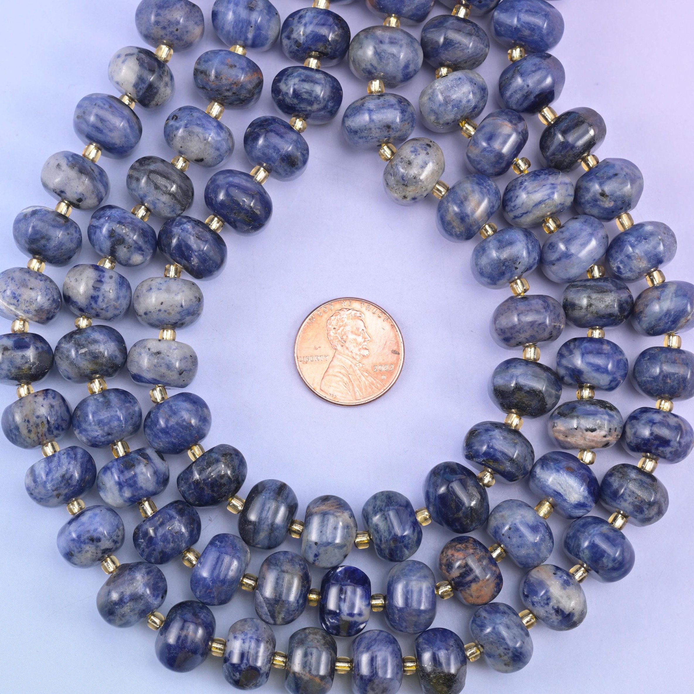 Sodalite smooth pumpkin beads in deep indigo-blue with natural white and gray veining