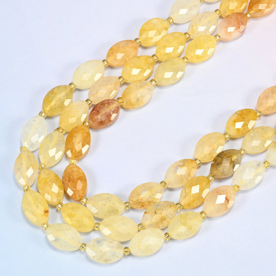 Golden healer quartz faceted flat oval beads in several strands curved into a wide U, golden yellow and honey stone