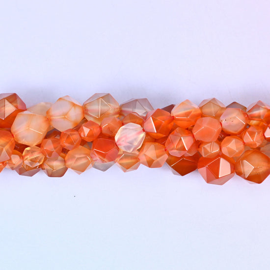 Orange Agate faceted beads close up in a single row, flat triangular star cut planes over orange and cream banding
