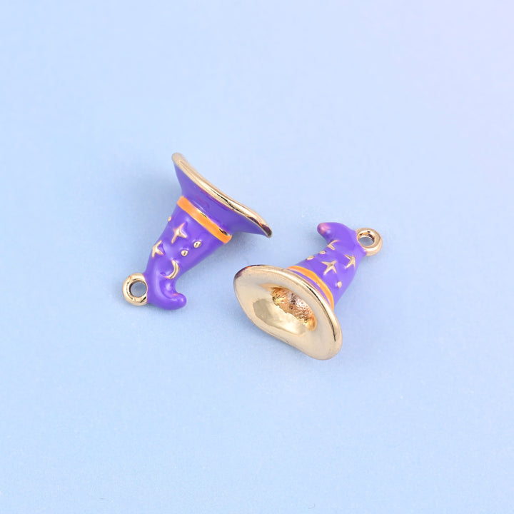 Enamel witch hat charms in purple, two hats lying on their sides with one showing the hollow gold-tone underside of the brim.