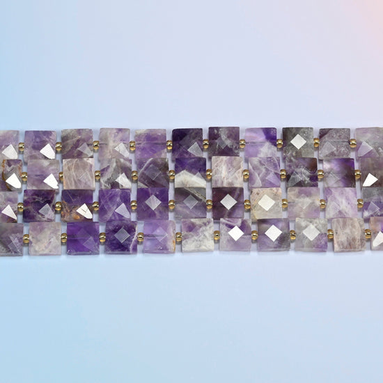 Several strands of natural amethyst faceted flat square beads laid in straight rows