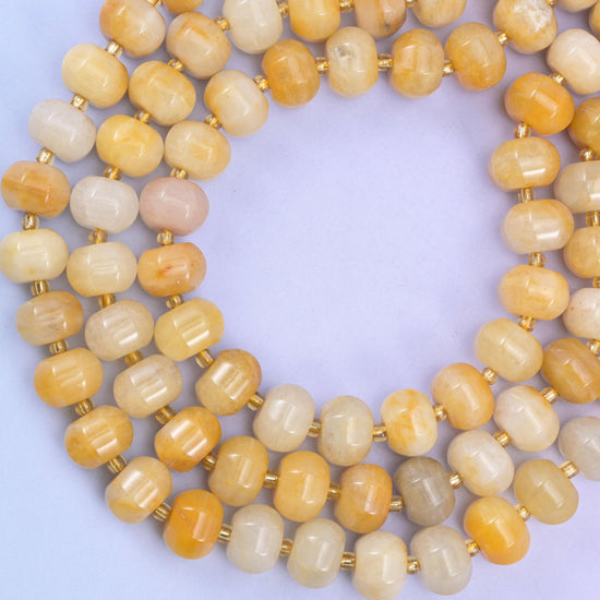 Yellow jade pumpkin beads, approximately 35 beads per strand