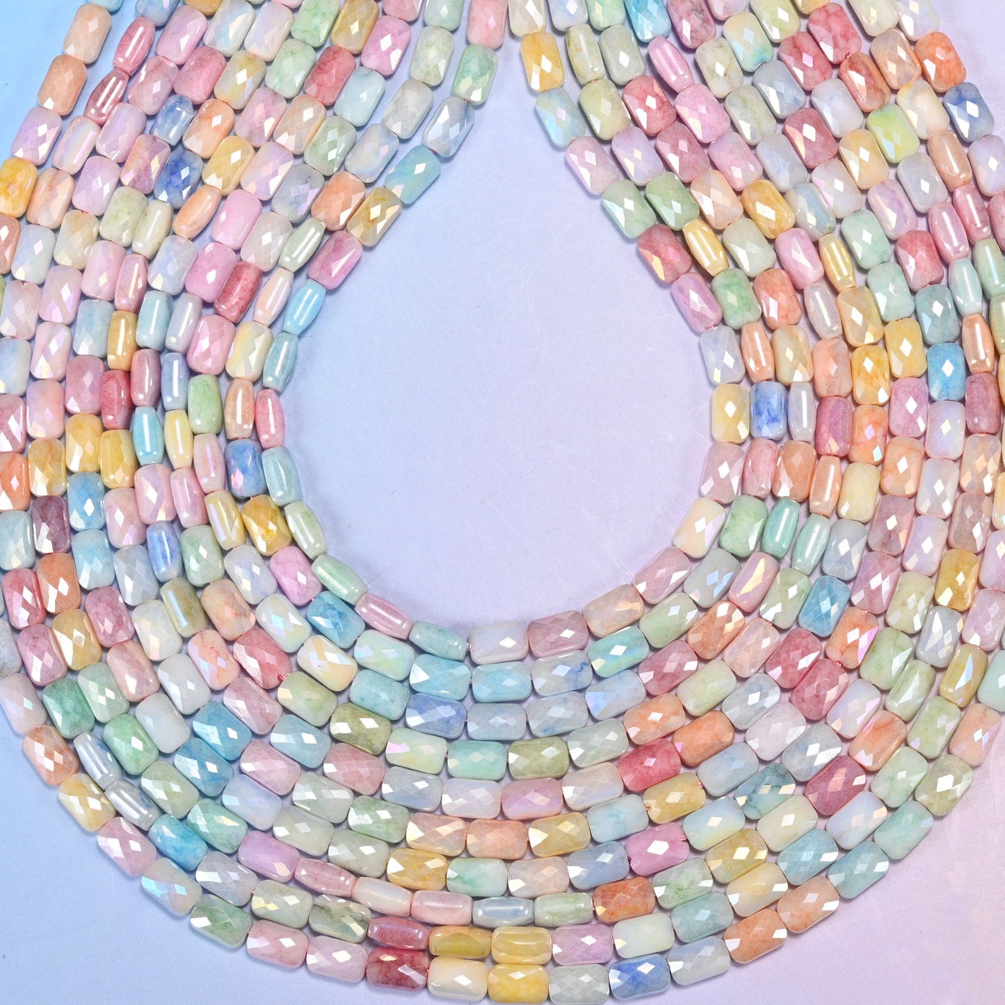 Faceted rectangle cut glass beads with a satin pearly lustre.