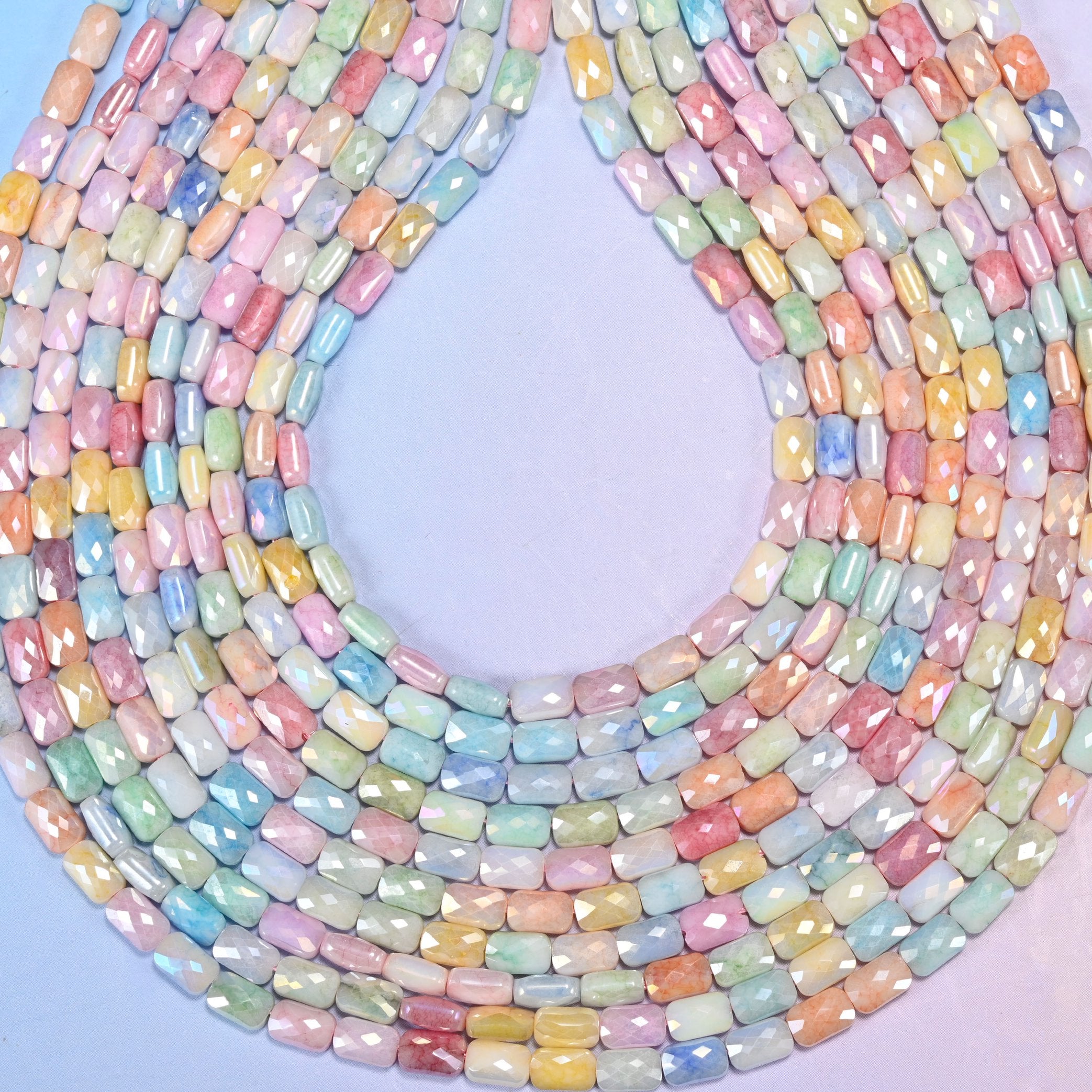 Faceted rectangle cut glass beads with a satin pearly lustre.