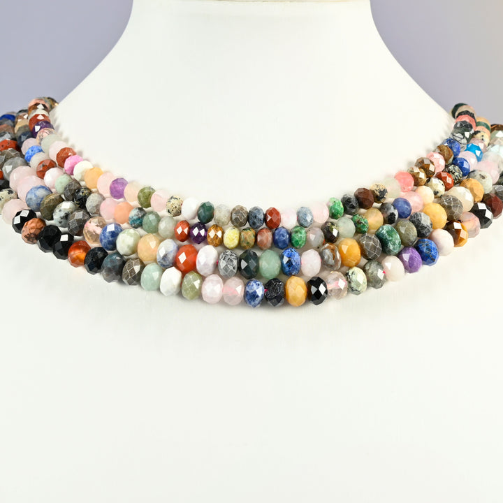 Colorful assorted gemstone faceted rondelle beads on a white neck display, four strands around the bust.