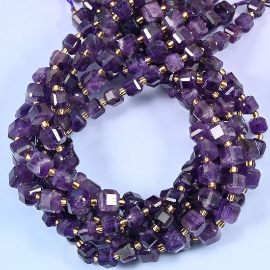 Deep grape purple cubes veined with paler lilac and milky white zoning, faceted at the corners so each flat face throws its own highlight.
