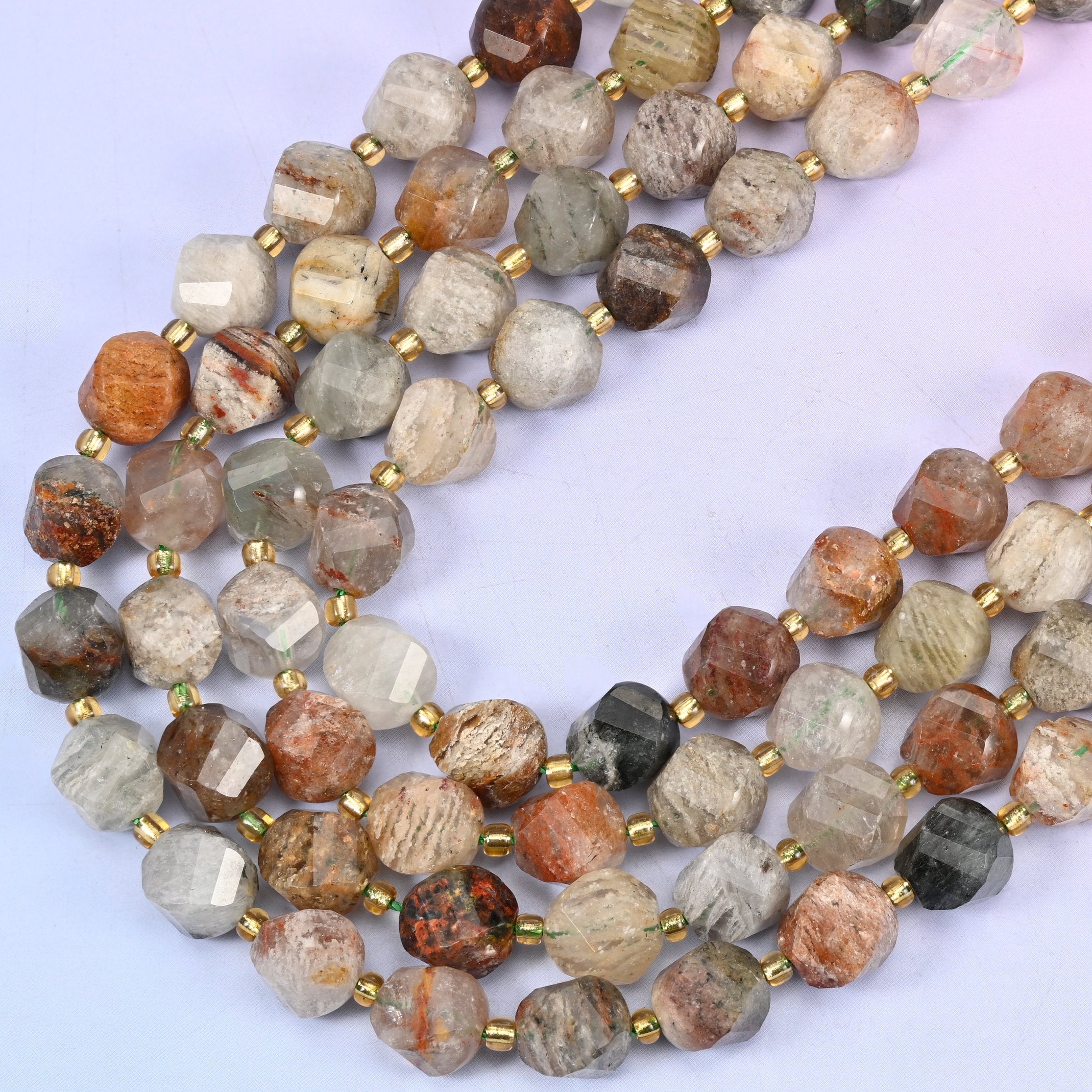 Thousand Layer Phantom Quartz natural crystal beads, many-sided spiral twist cut catching light on every facet, 10mm