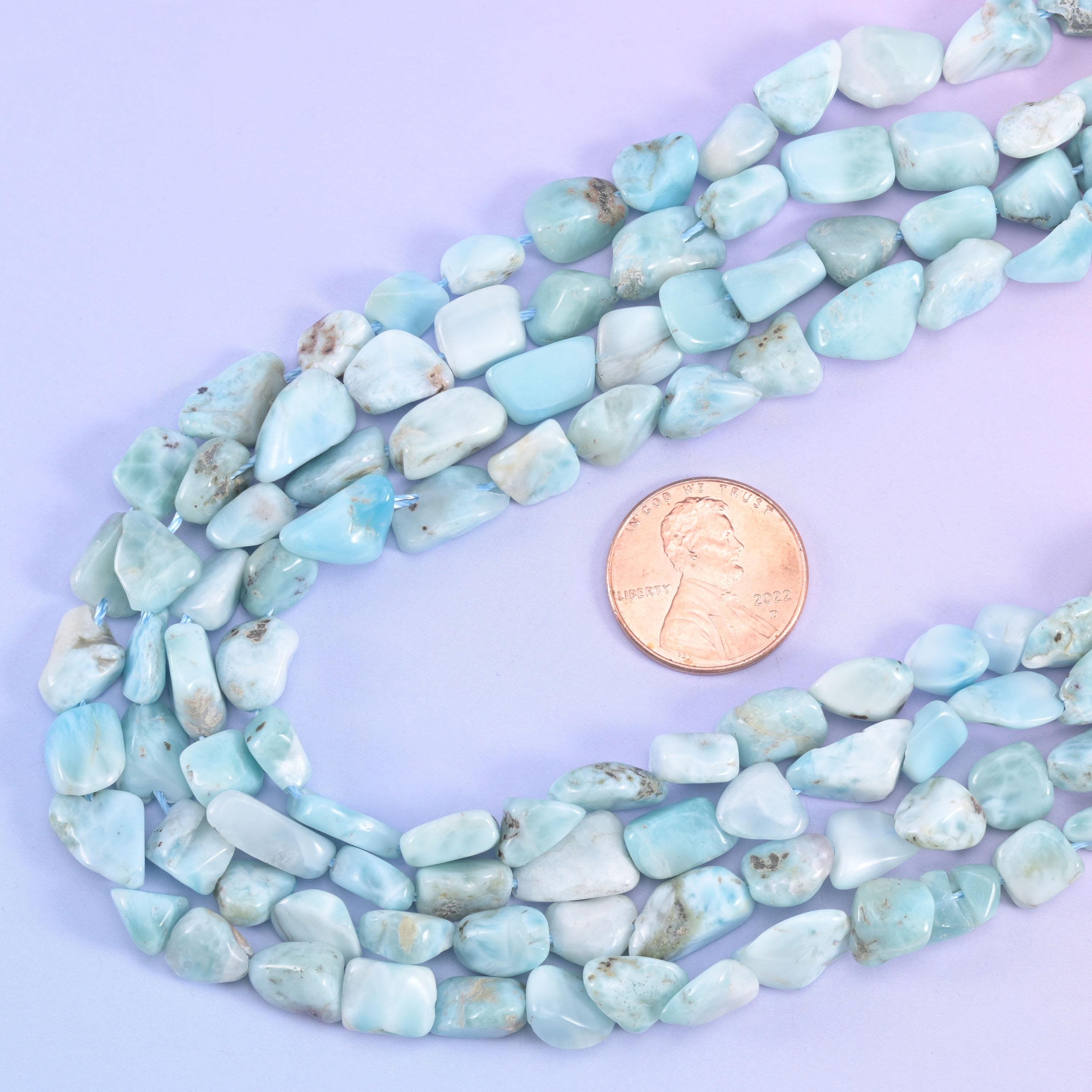 Nugget strands looped around a US penny, giving scale for the 6-8mm irregular beads
