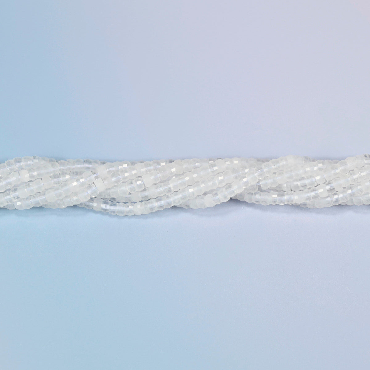 Strands of clear quartz faceted heishi disc beads twisted together in a horizontal row