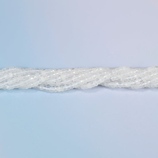 Strands of clear quartz faceted heishi disc beads twisted together in a horizontal row