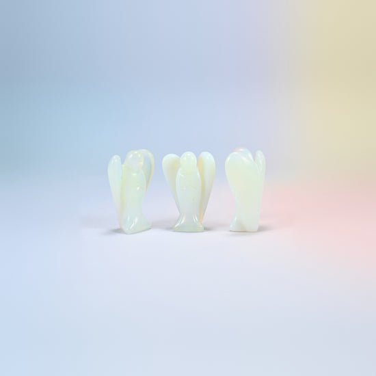 Three opalite guardian angel carvings, milky white with a blue glow, man-made glass, 2 inch