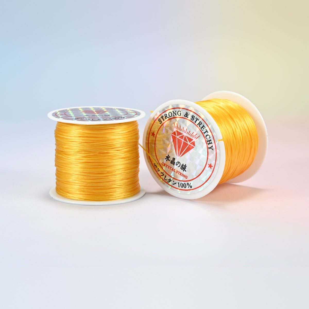 Two rolls of golden yellow 0.7-0.8mm elastic stretch string, glossy polyurethane bead cord with a holographic label