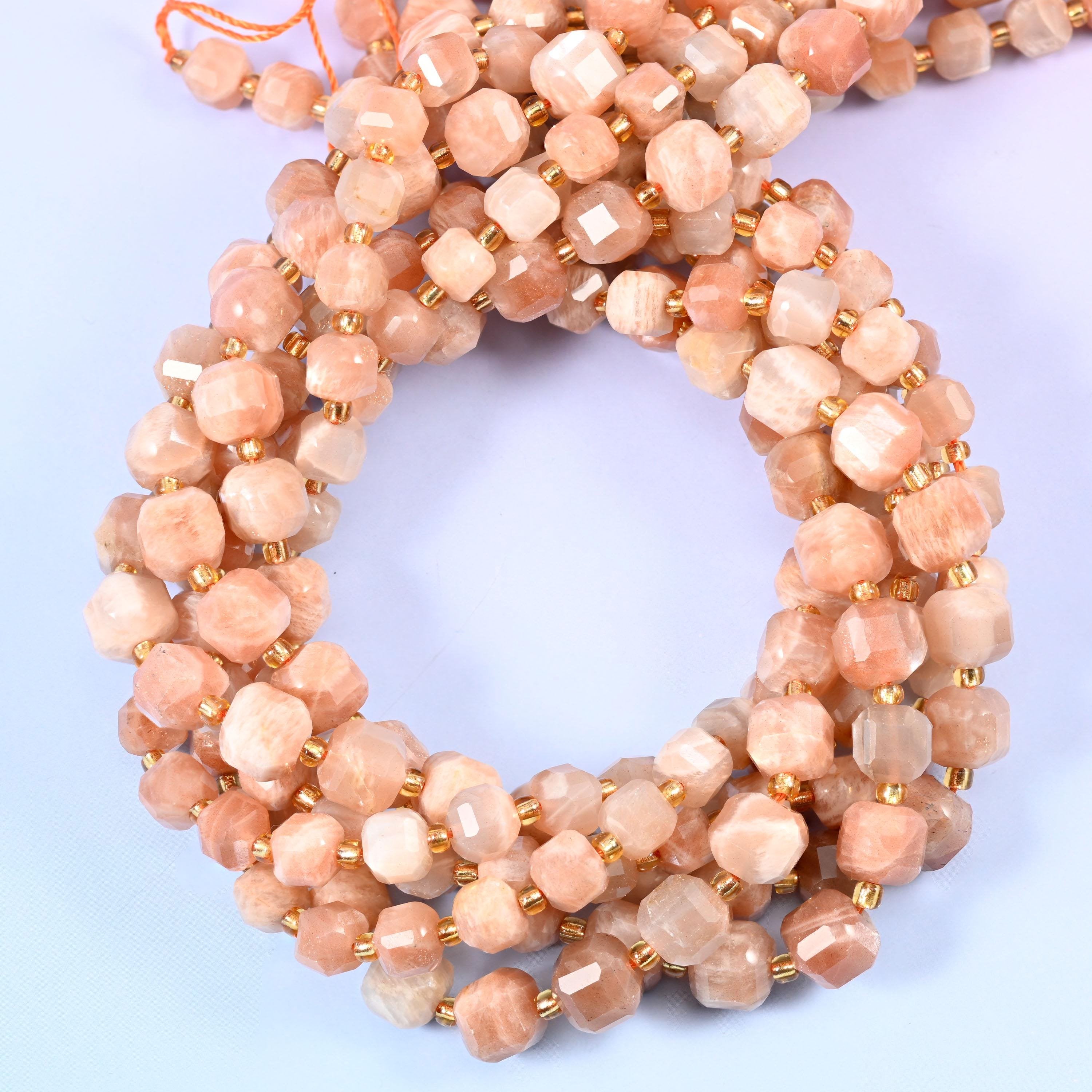 Warm apricot and cream cubes with a soft pearly sheen that lifts as each facet turns, corner-cut so the shimmer breaks across several planes at once.