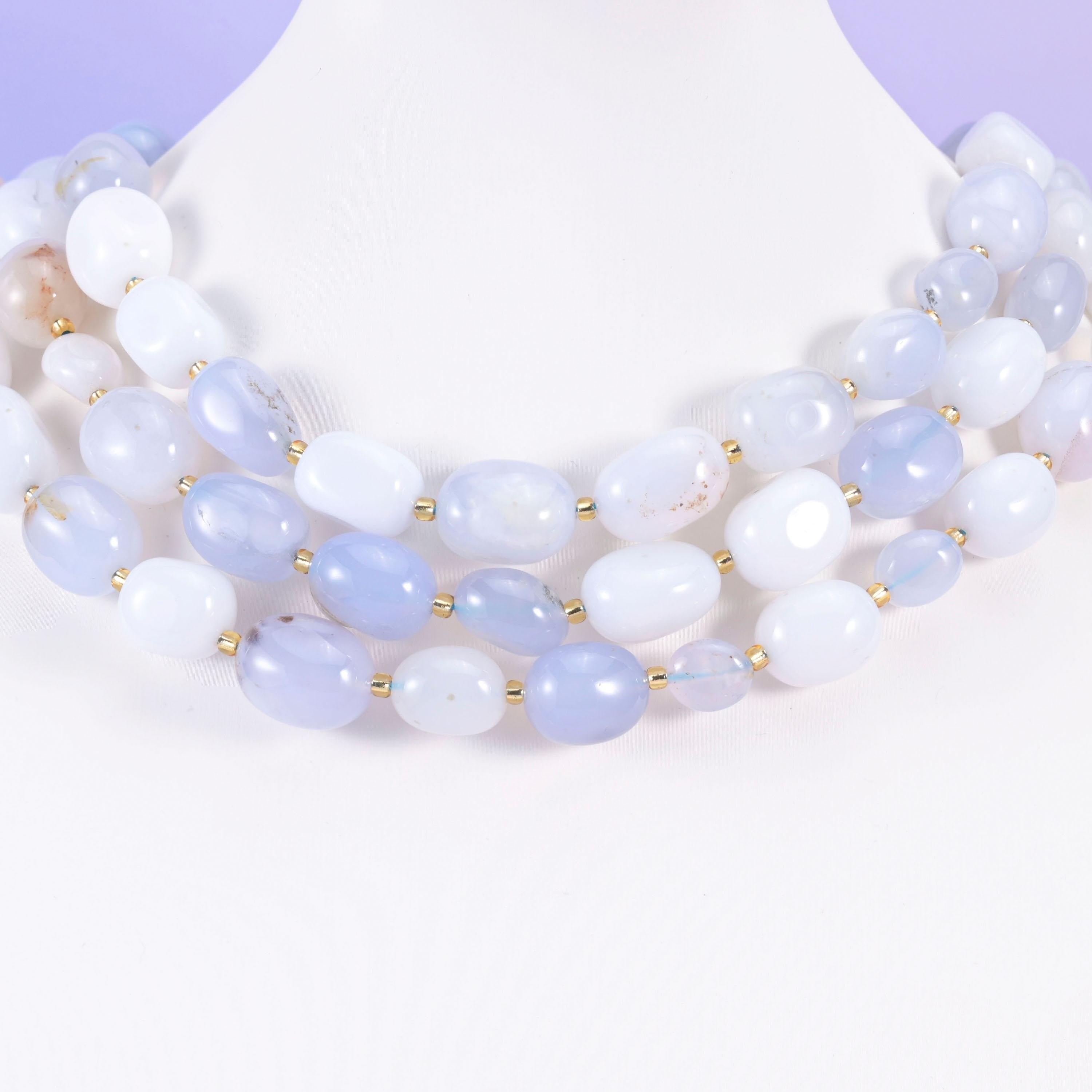 Soft blue and white chalcedony ovals styled on a white neck form, gold spacers between beads