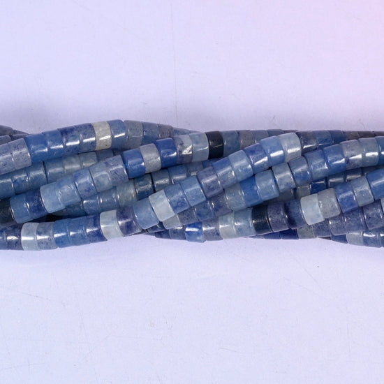 Natural Blue Aventurine smooth heishi disc beads in shades of soft powder blue to deep navy, finished with a polished, sophisticated look.