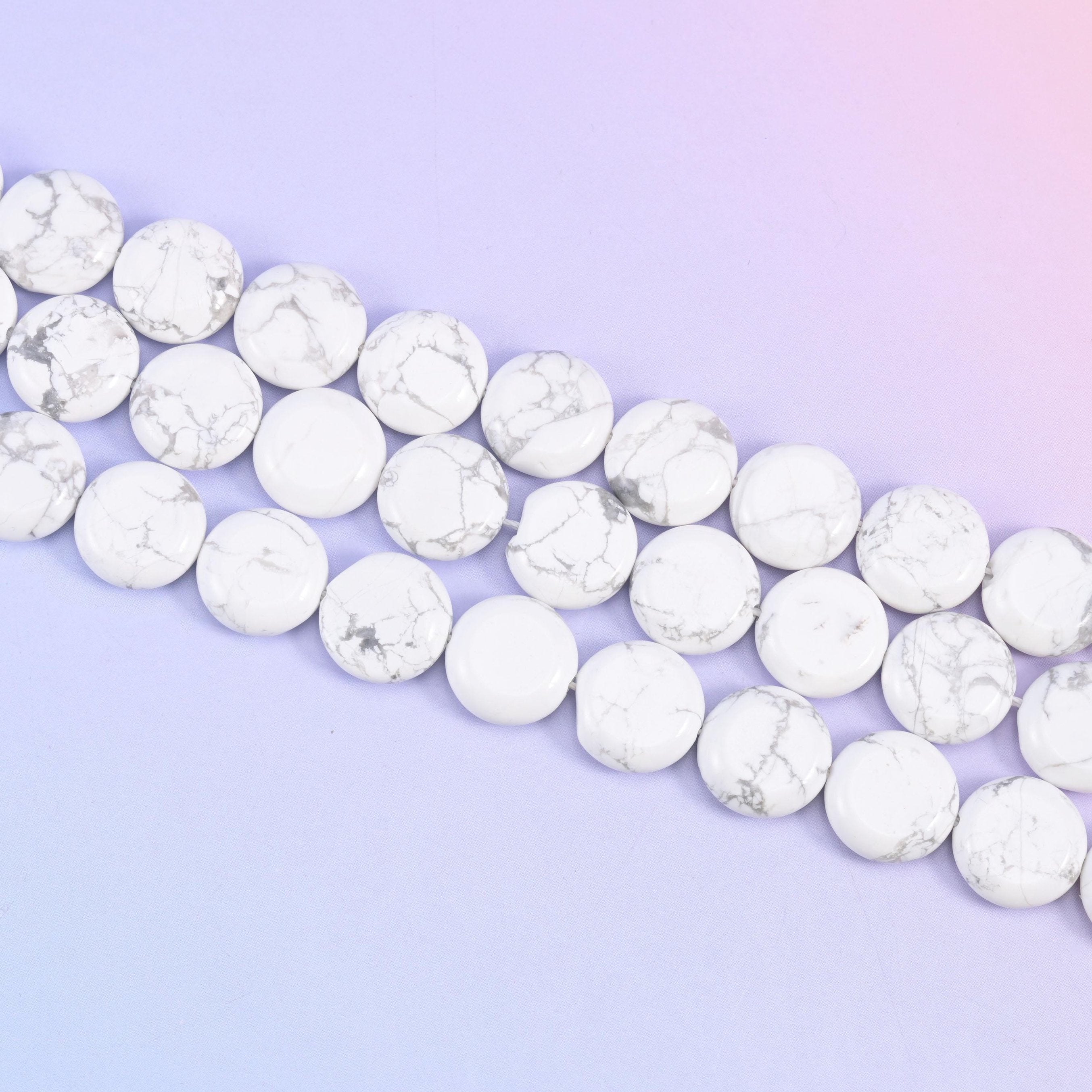 White Howlite coin beads with grey vein patterning across a white base