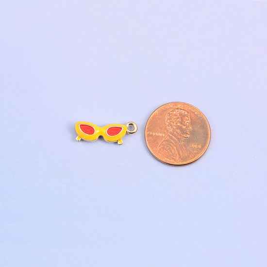 Yellow and red sunglasses charm shown at actual size, 18.02 x 6.84mm.