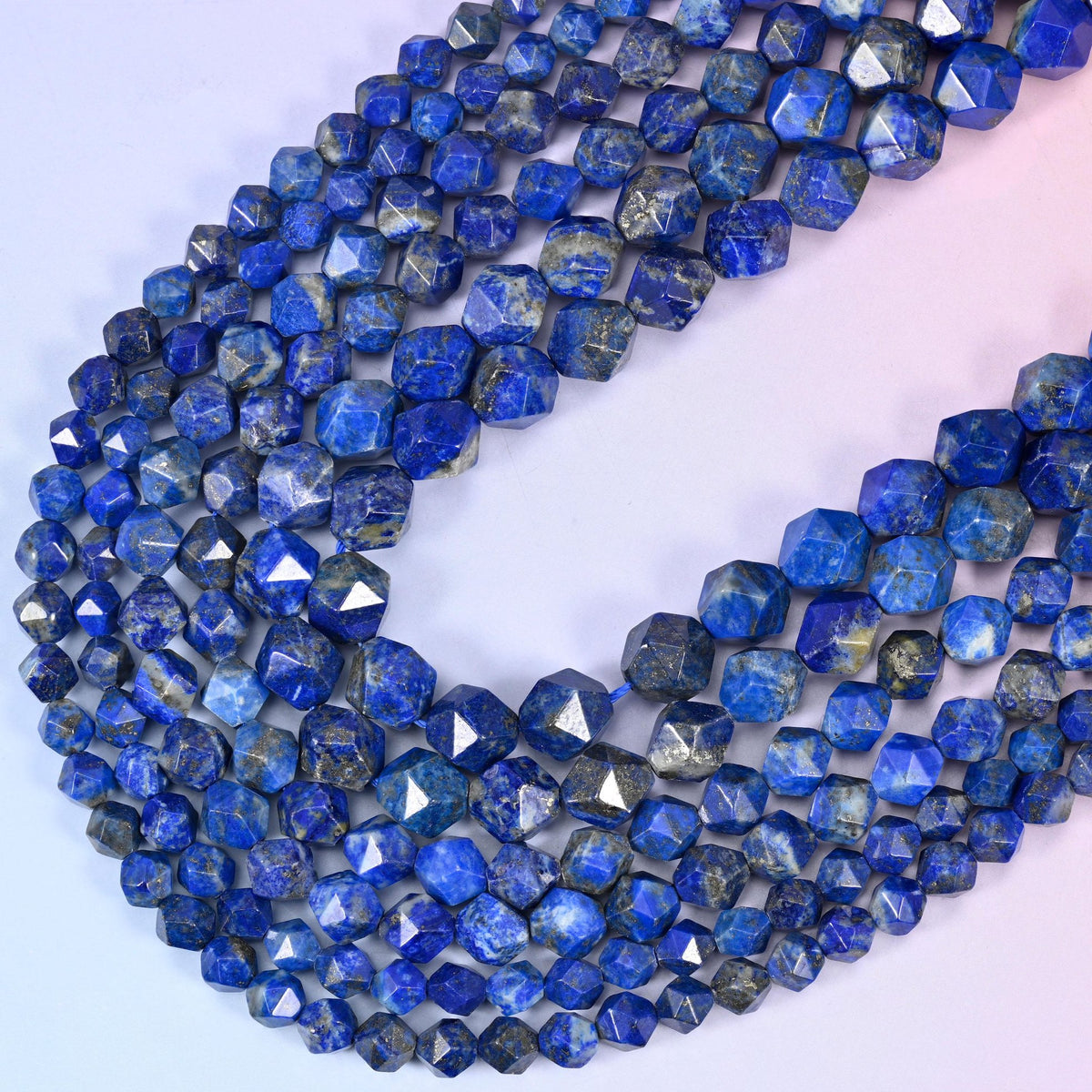 Blue Lapis Lazuli diamond star cut beads, strands crossing in a V, deep royal blue marbled with grey-white calcite