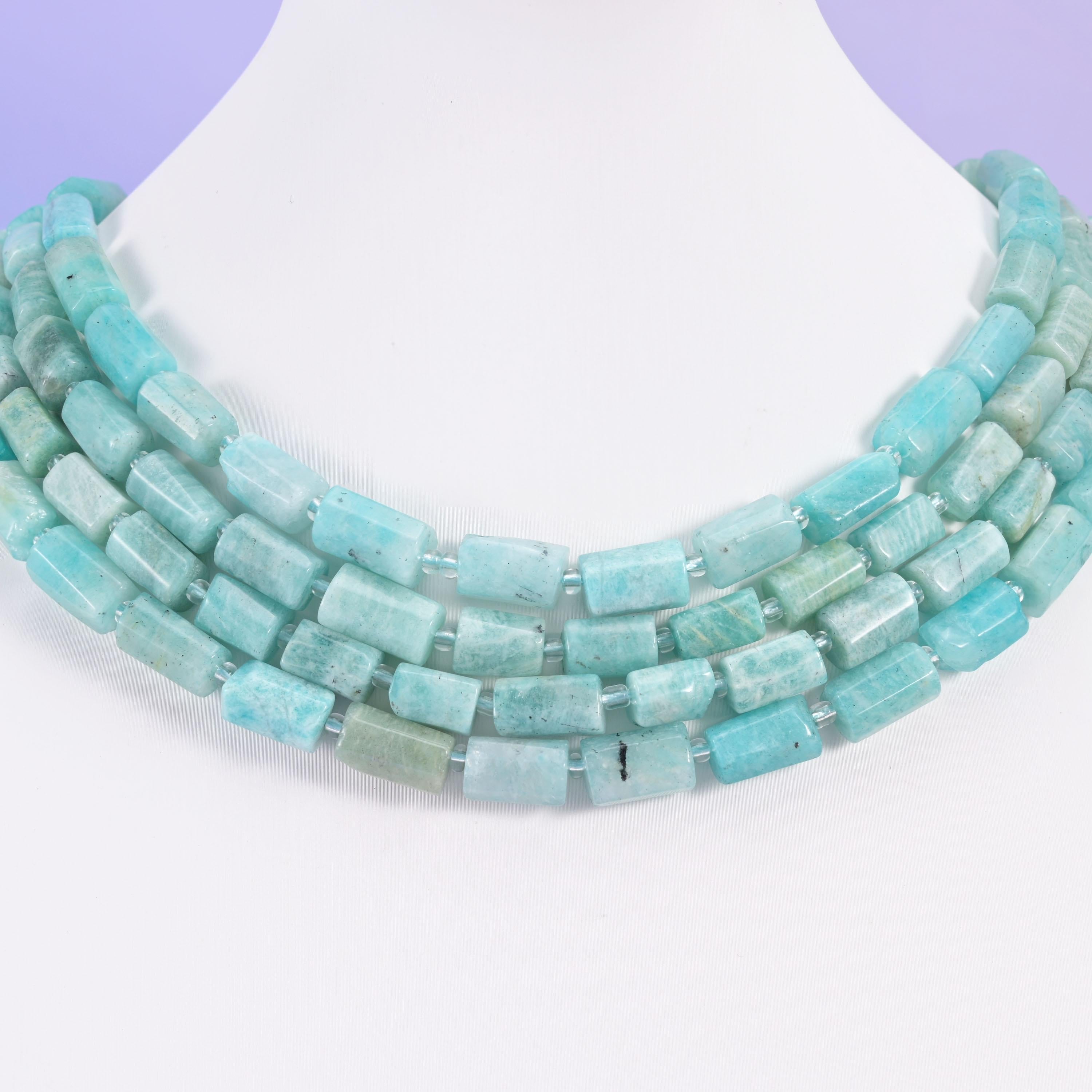 Blue Amazonite 12x8mm tube bead strands arranged as a layered multi-strand necklace on a white bust form
