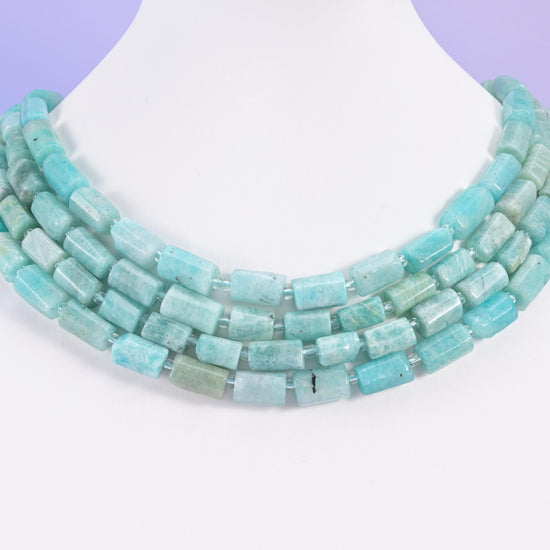Blue Amazonite 12x8mm tube bead strands arranged as a layered multi-strand necklace on a white bust form