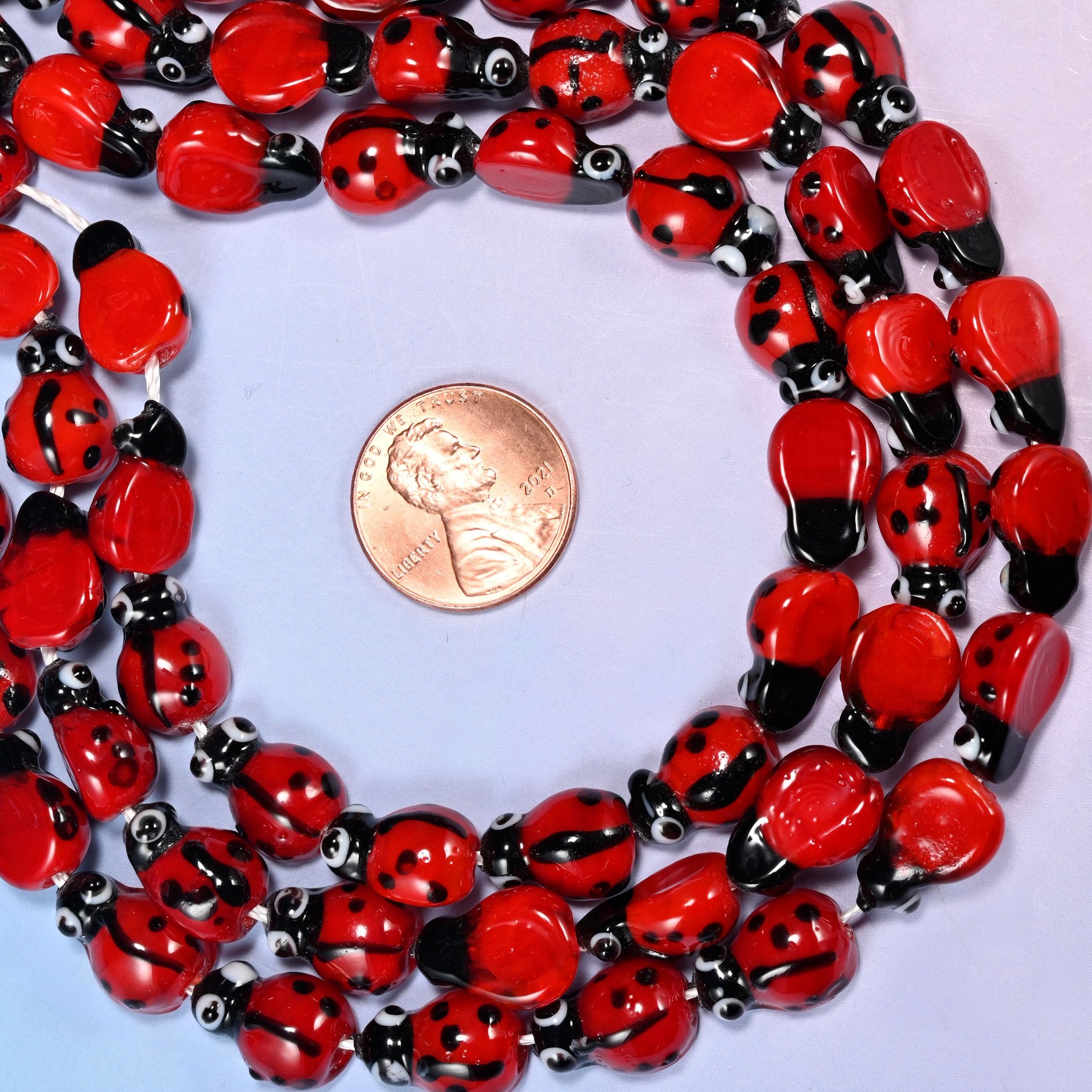 Ladybug glass beads, the roomy 1.5mm hole takes thicker elastic cord.