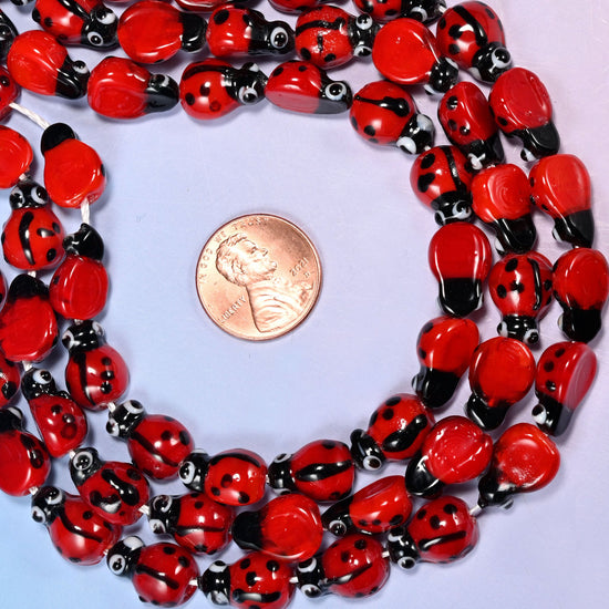 Ladybug glass beads, the roomy 1.5mm hole takes thicker elastic cord.