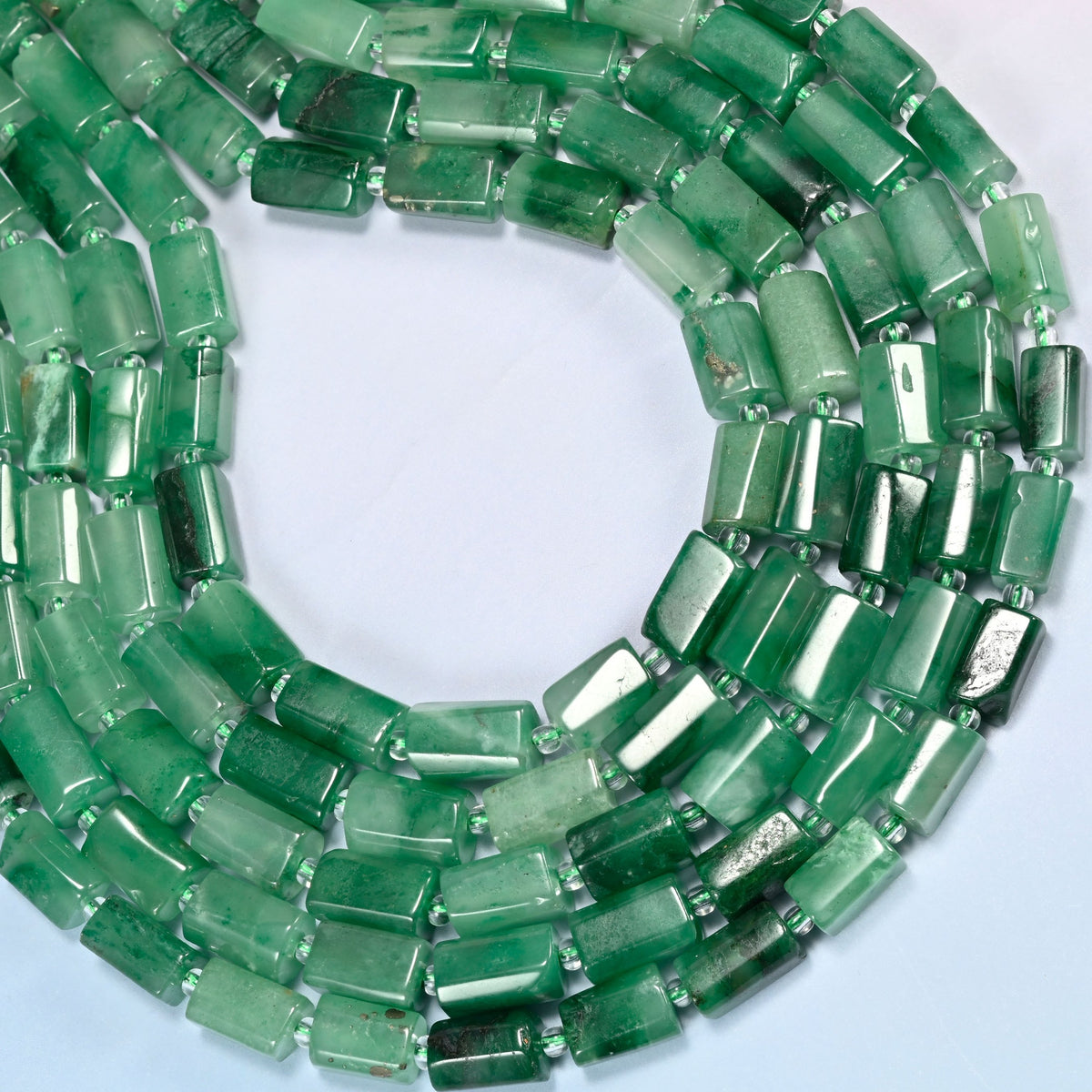 African jade faceted tube beads curved into an open loop, bright and deep green beads