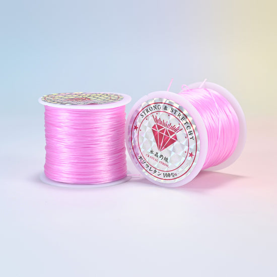 Two rolls of pink 0.7-0.8mm elastic stretch string, glossy polyurethane bead cord with a holographic label