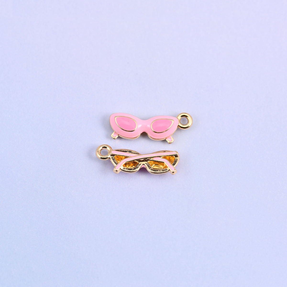 Pink cat eye sunglasses charm with light pink lenses, front and back.