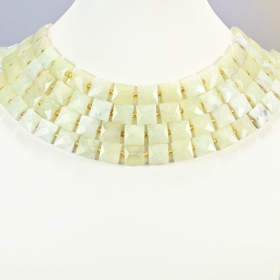 New Jade faceted flat square strands arranged as a layered collar on a white display bust, light yellow-green beads across the neck