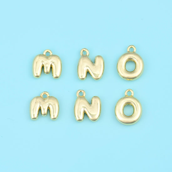 Rounded balloon-style capitals with a soft puffed profile and a smooth high-polish gold finish, each letter finished with a…