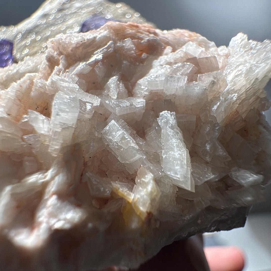 Sharp white crystal blades standing proud of the cream and pink matrix