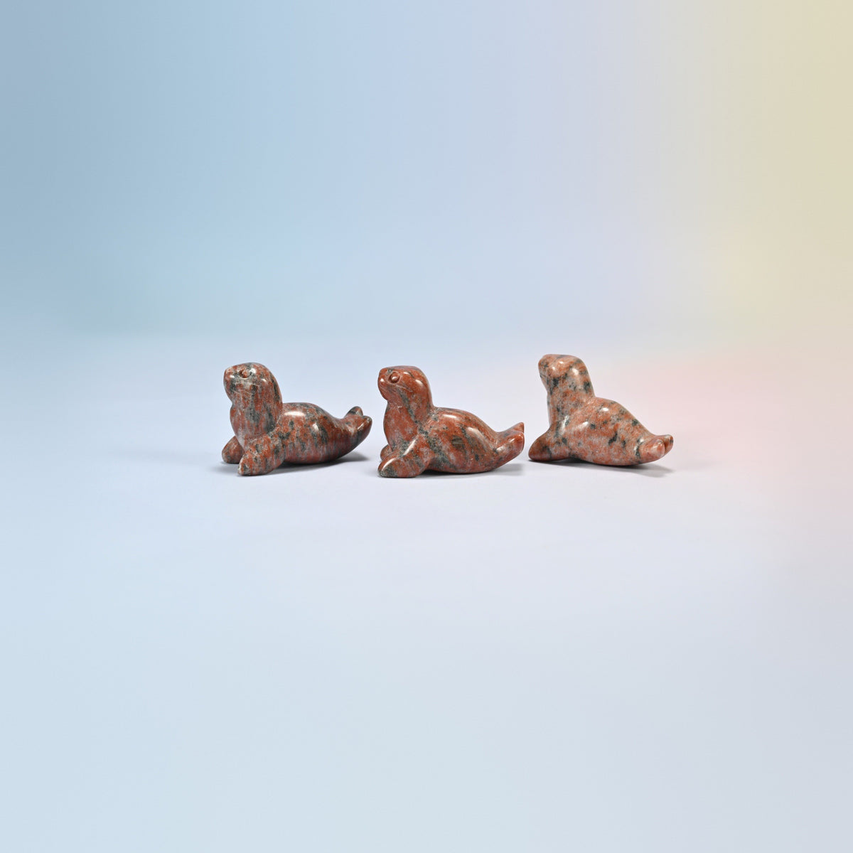 Three sesame jasper sea lion crystal carvings, 1.5 inch, salmon pink natural stone with dark spots